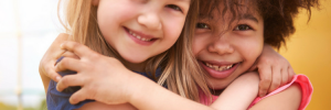 Two prepubescent girls hugging photo from Brest Cancer Prevention Partners